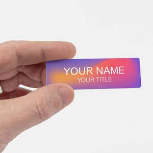 Hand holding a multicolored UV printed Name Tag