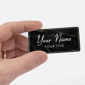 Black name tag in hand