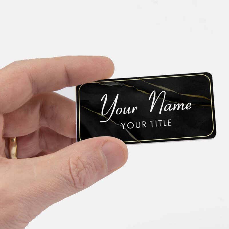 Black name tag in hand