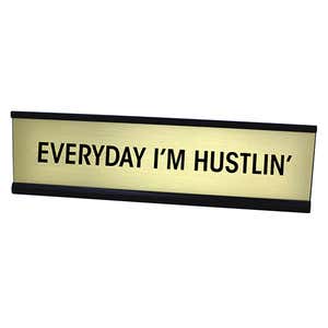 Gold desk plate with black custom text in black holder