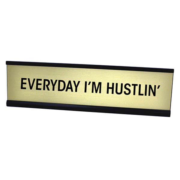 Gold desk plate with black custom text in black holder