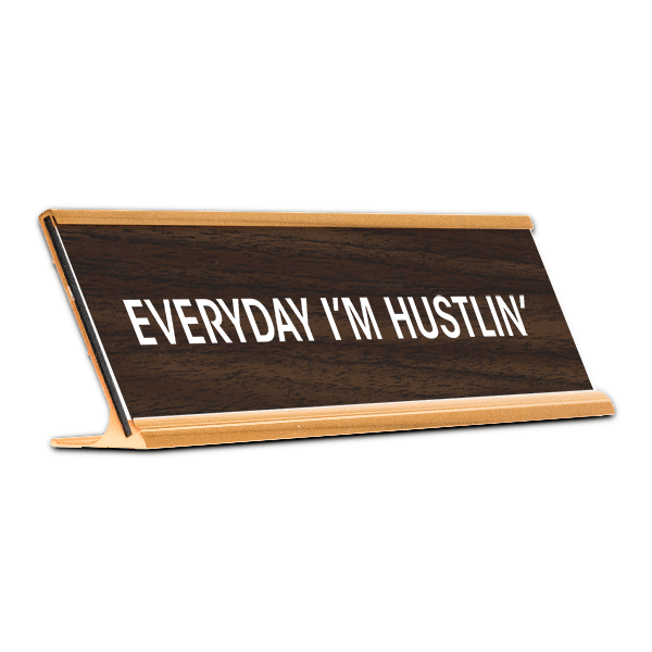 Black desk plate with white custom text in gold holder