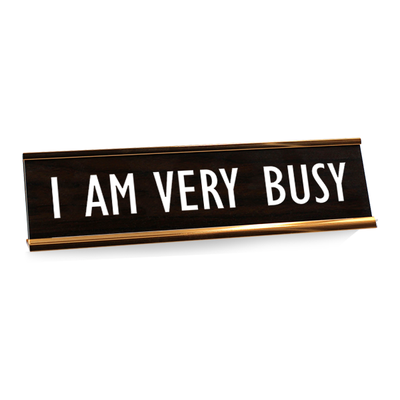 Black desk plate with white custom text in rose gold holder