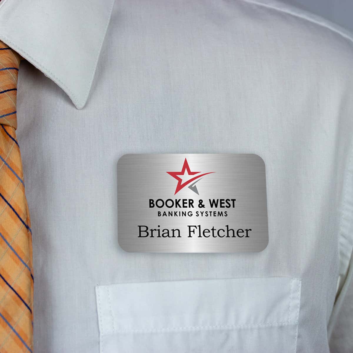 Dark blue full-color name tag - lead technician - worn on a light dress shirt for size perspective