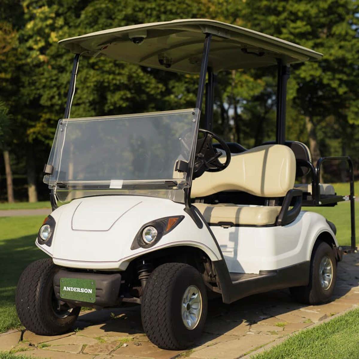 White Golf Cart with a Custom License Plate Saying "Anderson"