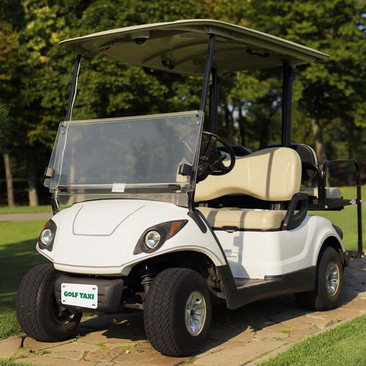 White Golf Cart with a Custom License Plate Saying "Golf Taxi"