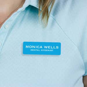 Engraved Plastic Custom Name Tag in Block Serif Font on Blue Polo Shirt