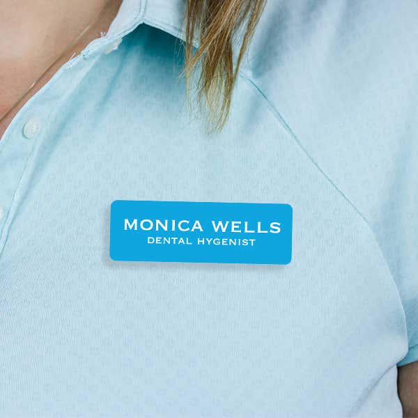 Engraved Plastic Custom Name Tag in Block Serif Font on Blue Polo Shirt