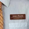 Engraved Plastic Custom Name Tag in Traditional Serif Font on White Shirt with Orange Tie