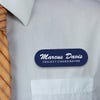 Engraved Plastic Custom Name Tag in Brushed Script Font on White Shirt with Orange Tie