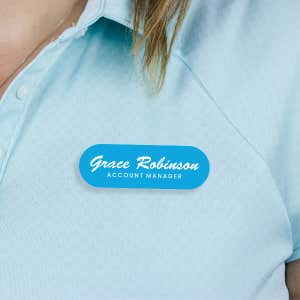 Engraved Plastic Custom Name Tag in Brushed Script Font on Blue Polo Shirt
