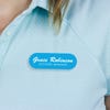 Engraved Plastic Custom Name Tag in Brushed Script Font on Blue Polo Shirt