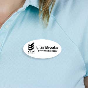 Engraved Plastic Custom Oval Name Tag with Oval Border on Blue Polo Shirt