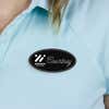 Engraved Plastic Upload Your Logo Custom Oval Name Tag in Elegant Cursive Font on Blue Polo Shirt