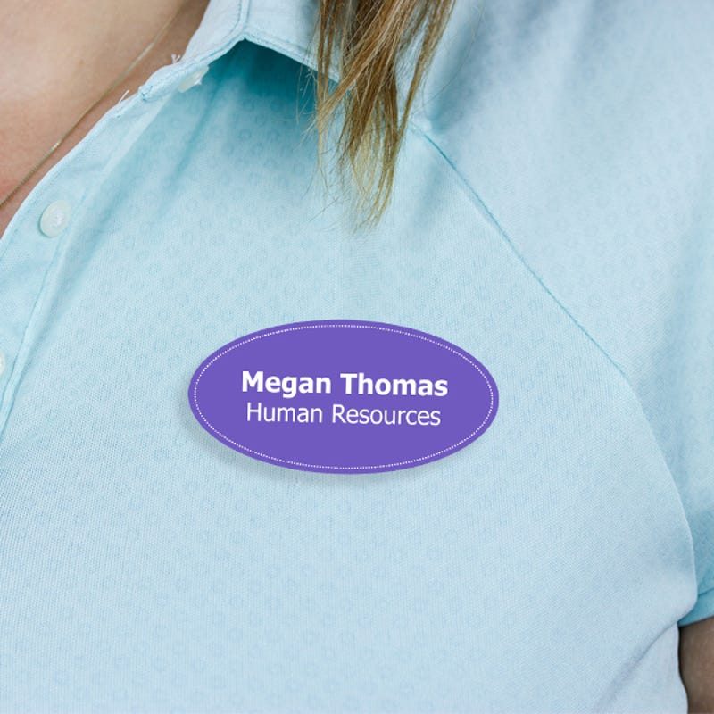 Engraved Plastic Custom Oval Name Tag with Oval Border on Blue Polo Shirt