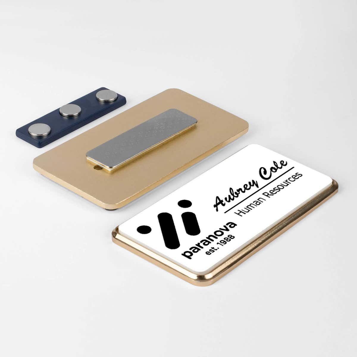 1.5x3 executive engraved name badge with gold beveled frame showing magnetic backing attachment — custom name tag for corporate and HR teams