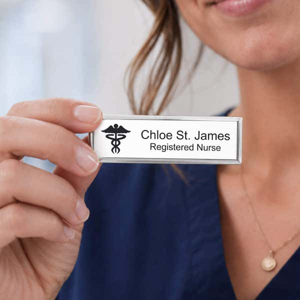 A nurse holding a name tag