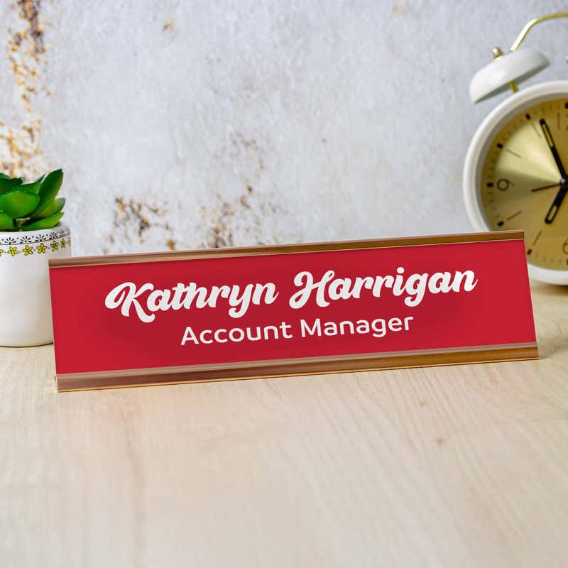 Kathryn Harrigan in Bold Script Style, Red with White Letters Desk Plate on Office Setting With Marble Background