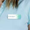 1" x 3" UV Printed Full Color Name Tag with Wave Pattern and Bold Condensed Custom Text on Blue Polo Shirt