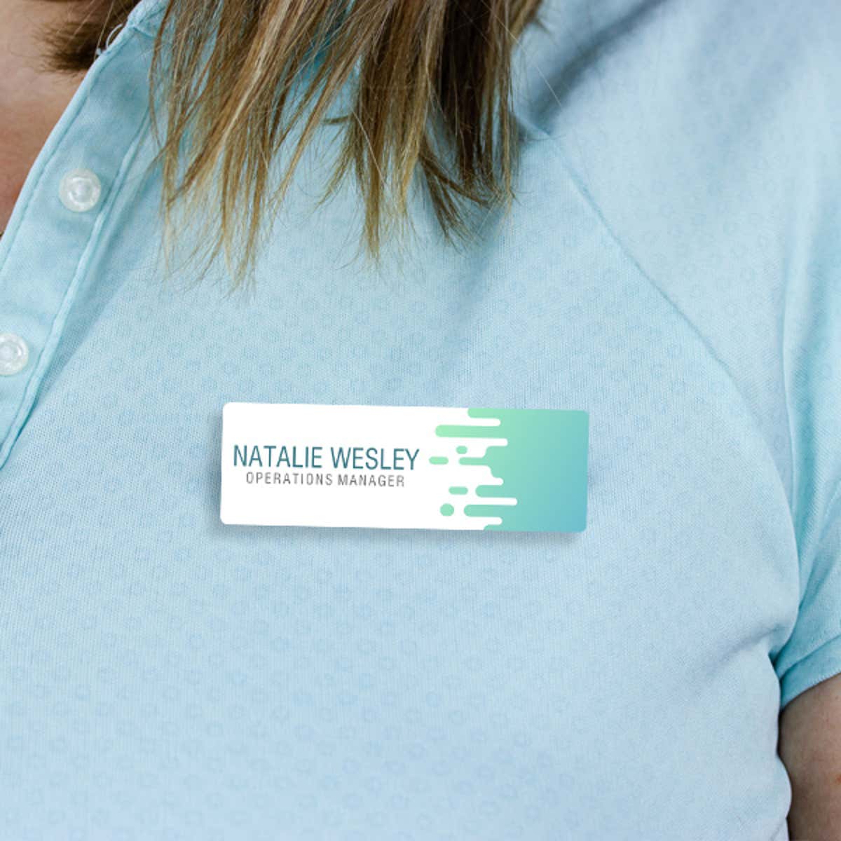 1" x 3" UV Printed Full Color Name Tag with Wave Pattern and Bold Condensed Custom Text on Blue Polo Shirt