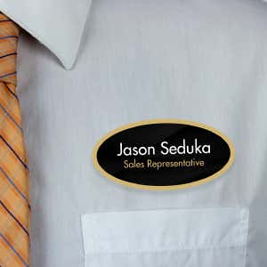 1.5" x 3" UV Printed Full Color Oval Name Tag on Corporate Black Background with Gold Outline on White Shirt with Tie