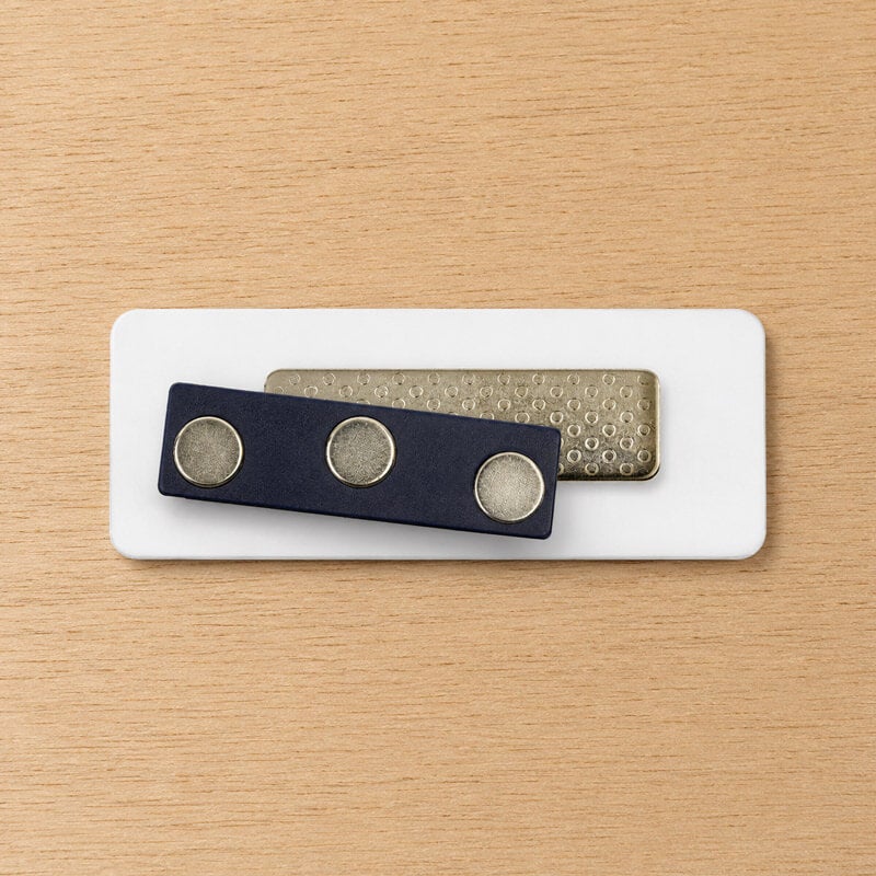 Magnetic name tag backing — two magnets hold badge without damaging clothing