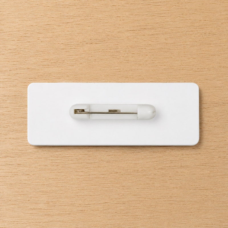 Pin backing for name tags — traditional safety pin attachment