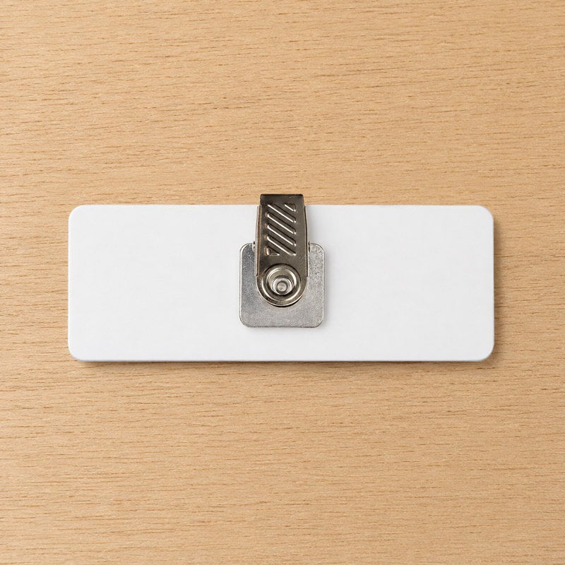 Swivel clip name tag backing — clips to pocket without piercing fabric